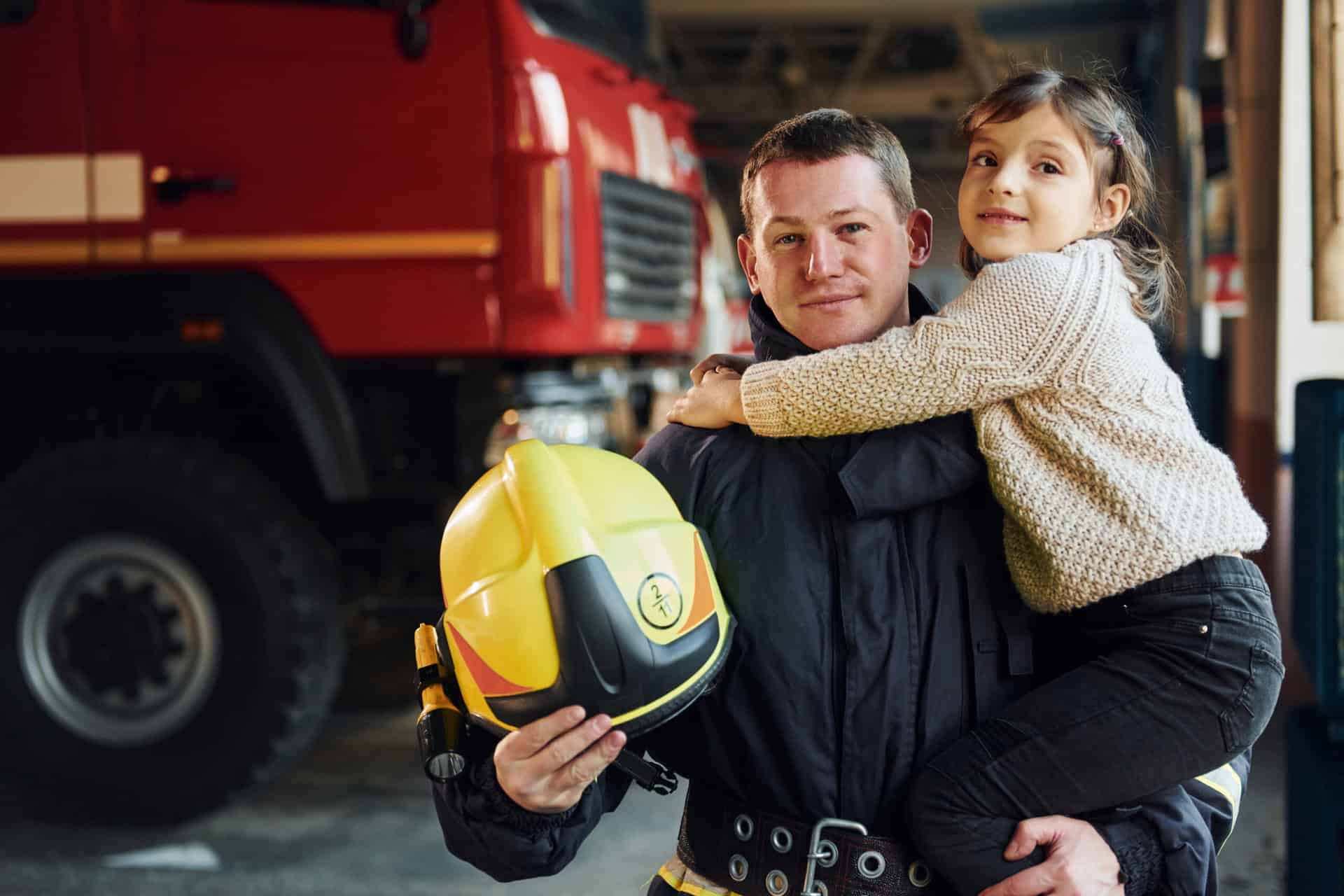 A concerned family sitting together on a couch, with a first responder in uniform looking distressed and holding their head in their hands. The family's faces show a mix of concern, empathy, and support, highlighting the impact of trauma on first responder families and the importance of family support.
